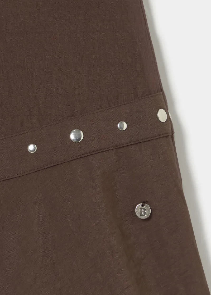 Short skirt with asymmetrical hem and studs
