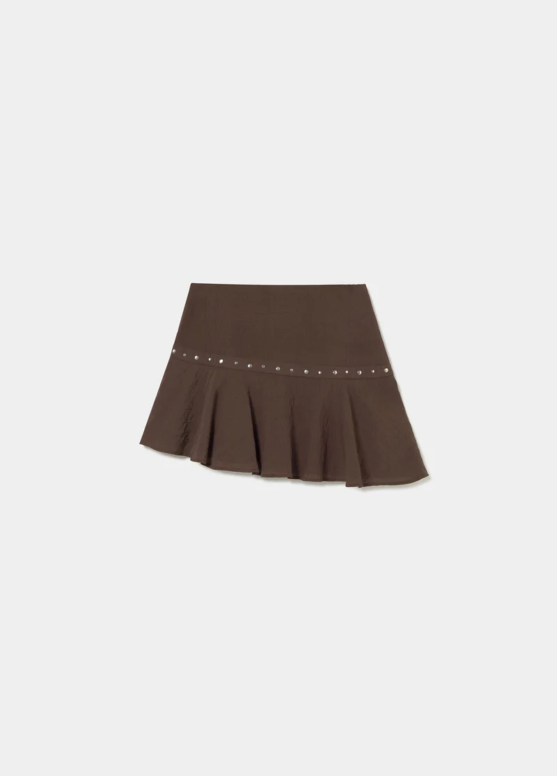 Short skirt with asymmetrical hem and studs
