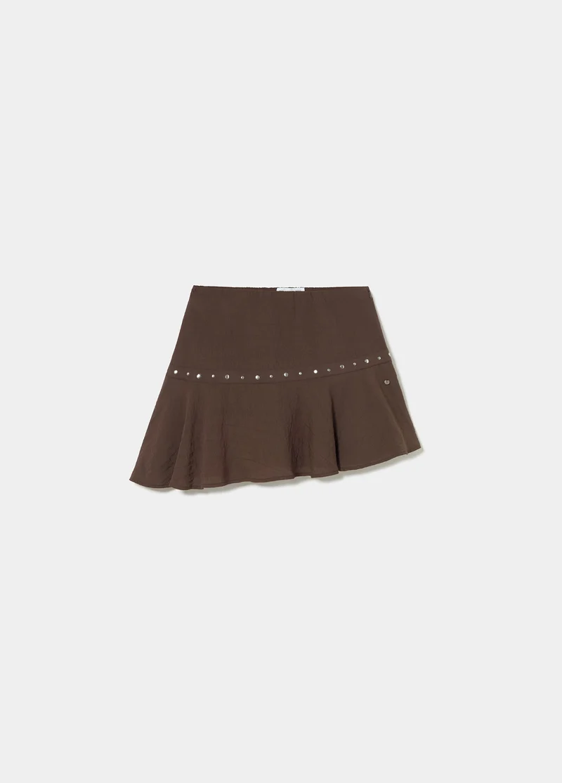Short skirt with asymmetrical hem and studs