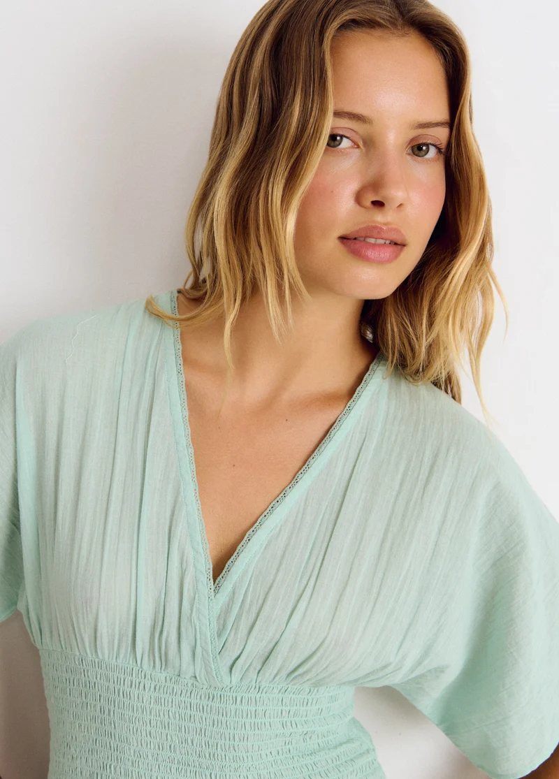 Embroidered smocked blouse