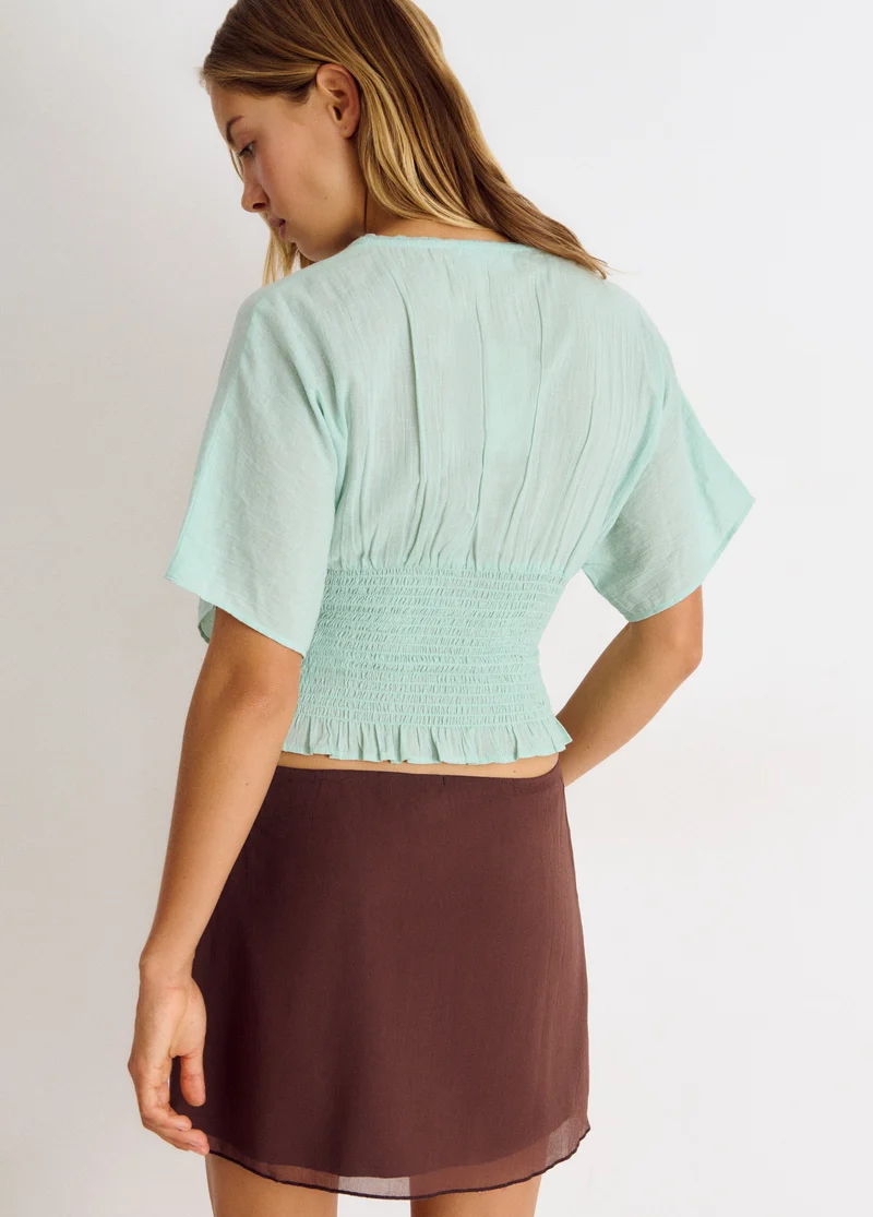 Embroidered smocked blouse